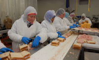 AdvancePierre Foods employees assemble legacy Landshire-branded wedge sandwiches and line them up to be sliced