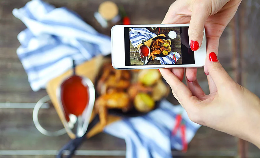 A Diner Snaps a Picture of Their Meal on Their Cell Phone