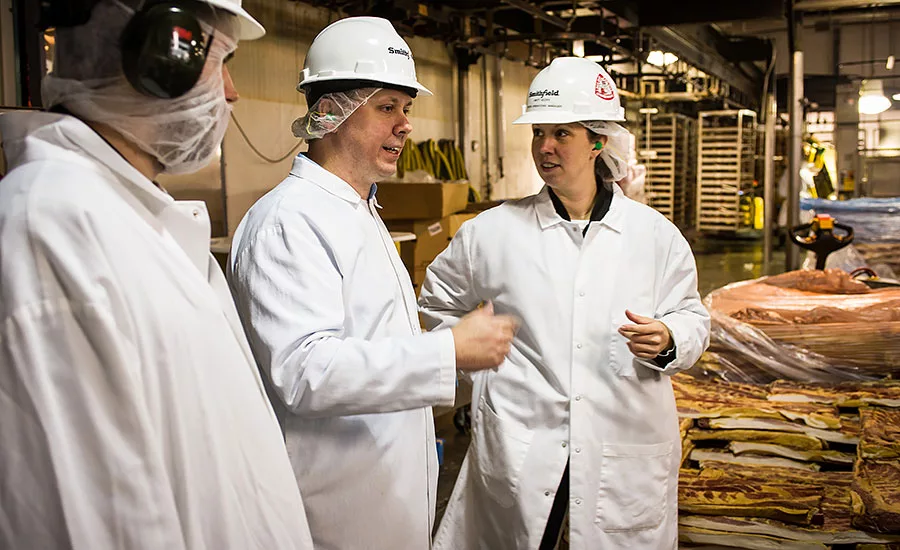 Brittany Scopa and Brandon Speight walk Andy Hanacek through Smithfield's Va. plant renovations
