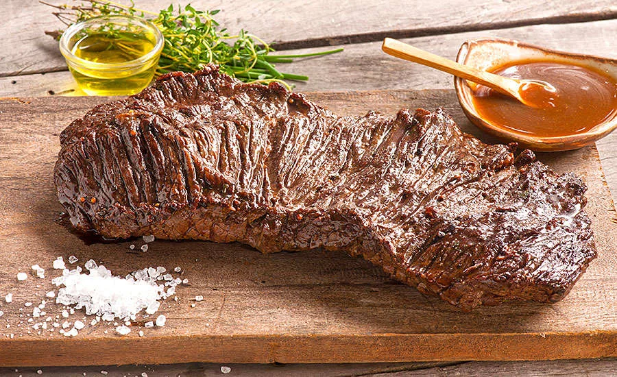 Cut of Meat Being Seasoned