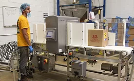 J.O. Spice Employee Next to Signature Touch Metal Detector From Mettler-Toledo Safeline