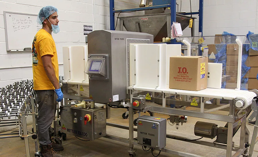 J.O. Spice Employee Next to Signature Touch Metal Detector From Mettler-Toledo Safeline