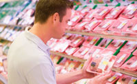 Retail Consumer Looks at Package of Beef