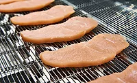 Strips of Chicken on Conveyor