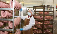 Employee in Sausage Processing Facility