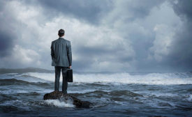 Business Man Standing on Rock in Water