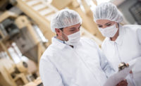 Two Meat Plant Workers Wearing Food Safety Apparel