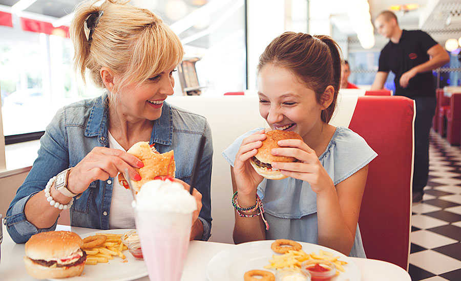 Mom and Daughter Eating Hamburgers