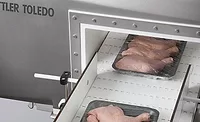Packages of Chicken Going Through Metal Detection Equipment Packages of Chicken Going Through Metal Detection Equipment