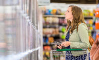 Woman Looking at Frozen Food in Grocery Aisle