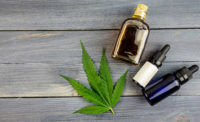 Marijuana Leaf and Bottles of CBD Oil