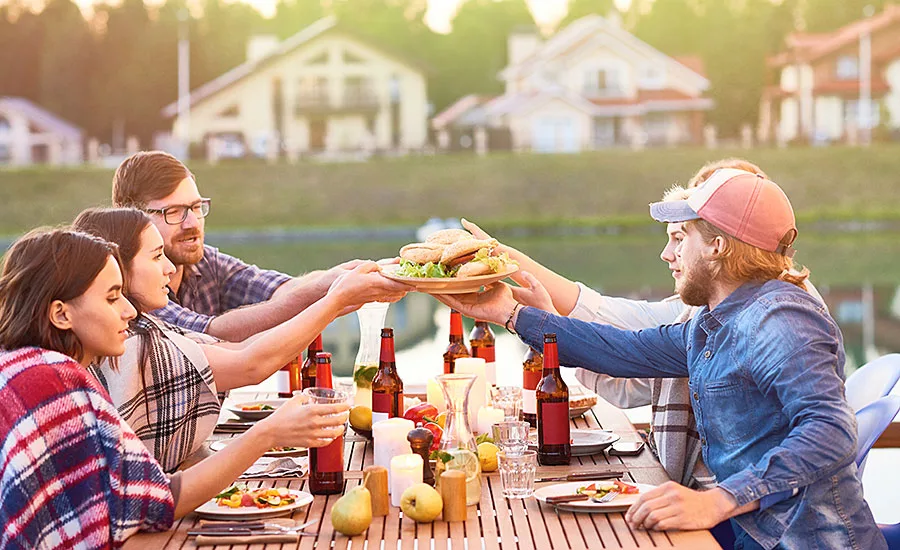 Group at Table Passing Plate of Burgers