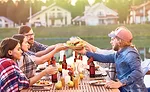 Group at Table Passing Plate of Burgers