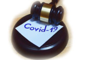 gavel with Covid-19 on a sticky note