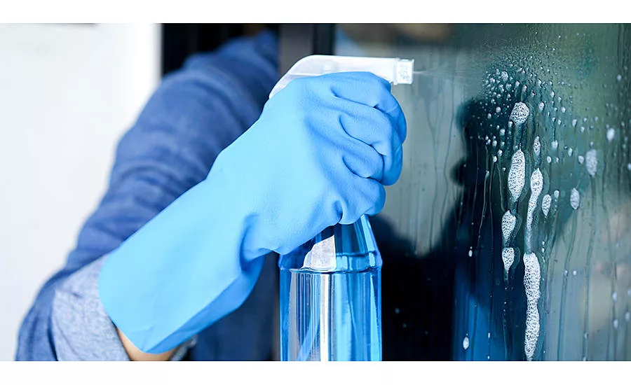 gloved hand with a spray bottle