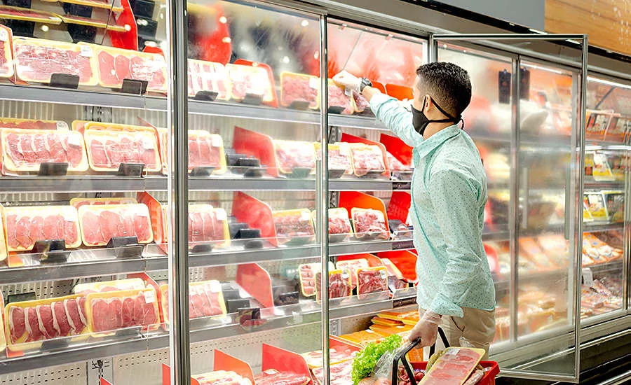 man shopping in the cooler aisle