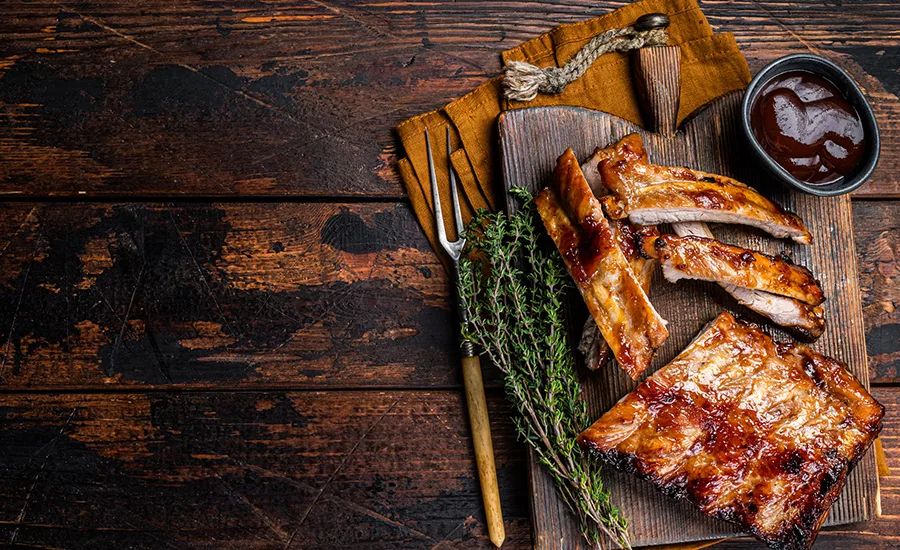 Overhead shot of cooked pork ribs and sprigs of thyme.