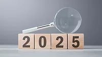 2025 Wooden Blocks 2025 wooden blocks with a magnifying glass laid on top.
