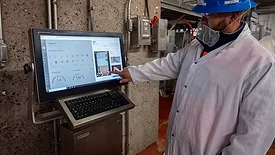 A processor employee in safet gear using the CarVe system.
