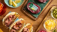Verde Farms Sirloin Steak package on a board and steak tacos.