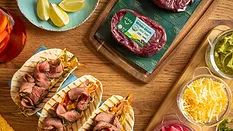 Verde Farms Sirloin Steak package on a board and steak tacos.