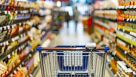 a grocery store aisle from the perspective of someone pushing a shopping cart