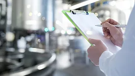 a professional conducting a food safety inspection in an industrial processing facility