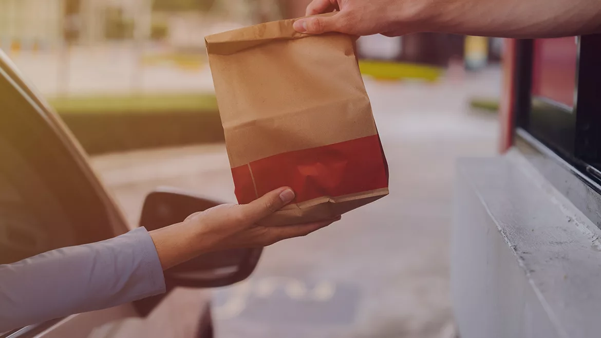 This stock image depicts a common drive-thru service interaction