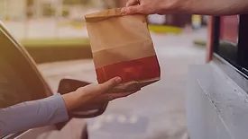 This stock image depicts a common drive-thru service interaction