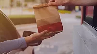 This stock image depicts a common drive-thru service interaction This stock image depicts a common drive-thru service interaction