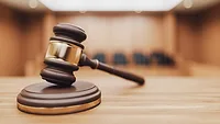 a wooden judge's gavel resting on a sound block a wooden judge's gavel resting on a sound block