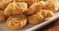 Breaded chicken nuggets Breaded chicken nuggets on a white plate.