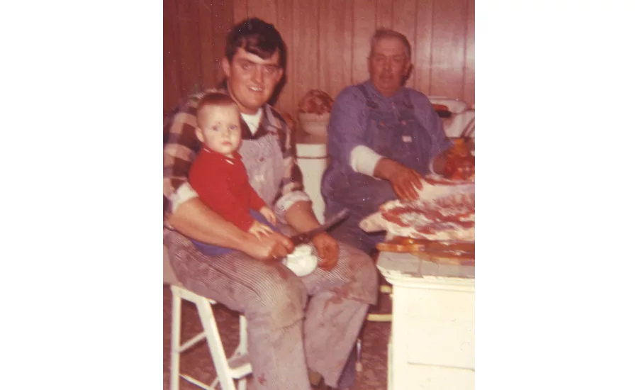 An old family photo of Sam Western introducing son Kevin to meat processing