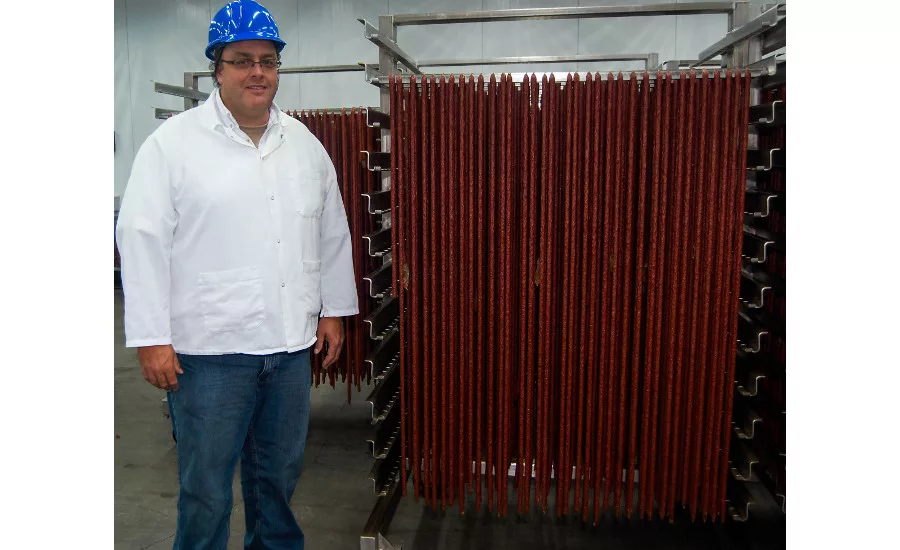 Kevin Western next to ropes of uncut snack sticks