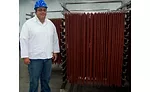 Kevin Western next to ropes of uncut snack sticks