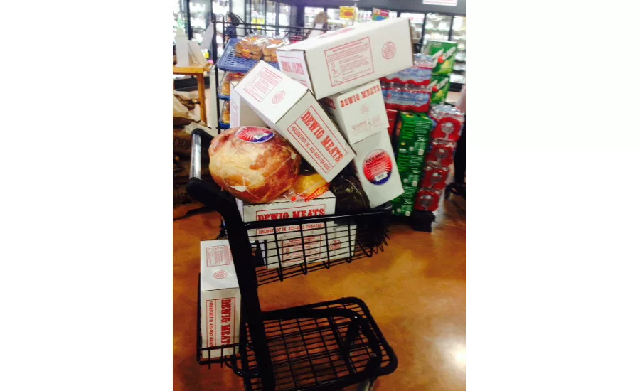 A cart loaded with Dewig Meats products inside the retail store