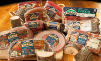 A variety of Petit Jean Meats products including ham, sausage, bacon, and bologna