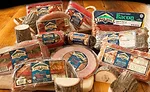A variety of Petit Jean Meats products including ham, sausage, bacon, and bologna