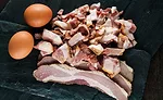 Two Eggs Next to Bacon