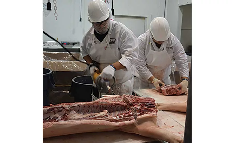 Two Paradise Meats Workers Process Specialized Cuts from Pork Carcass