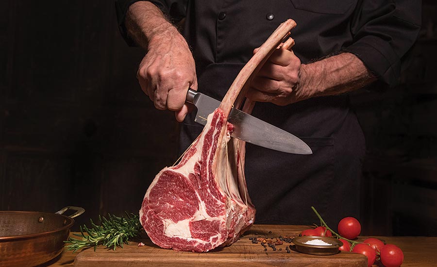 Chef Cutting Meat Off Bone