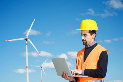 man with laptop, wind turbine, sustainability 