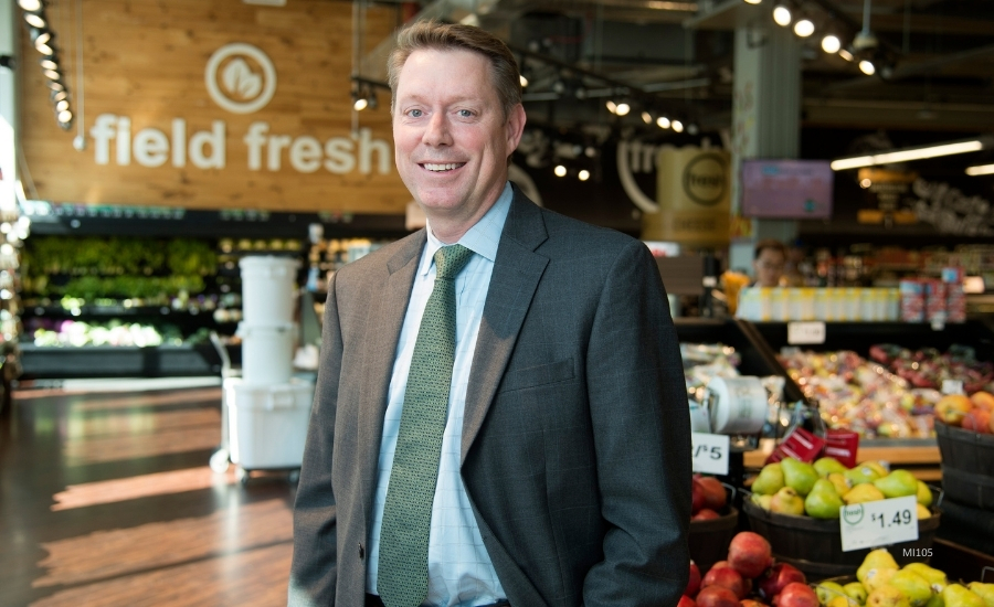 Dr. Jayson Lusk at a grocery store in the fruit and vegetable section, a "field fresh" sign in the background.