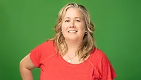 Anne Malleau headshot on a green background.