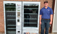 Joe Reams stands with RJ's Meats meat vending machine