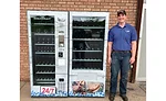 Joe Reams stands with RJ's Meats meat vending machine