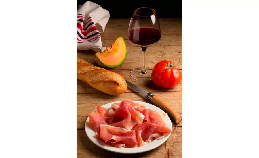 Bayonne Ham With Bread, Fruits, and Wine on Table