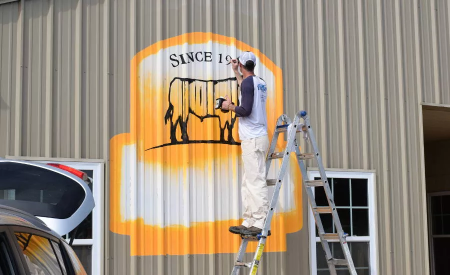 Troy Freeman Works on the Certified Angus Beef (CAB) Logo at CAM Ranches